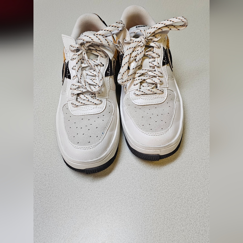 White, yellow and brown women nike tennis shoes. Size(6.5)-Used.